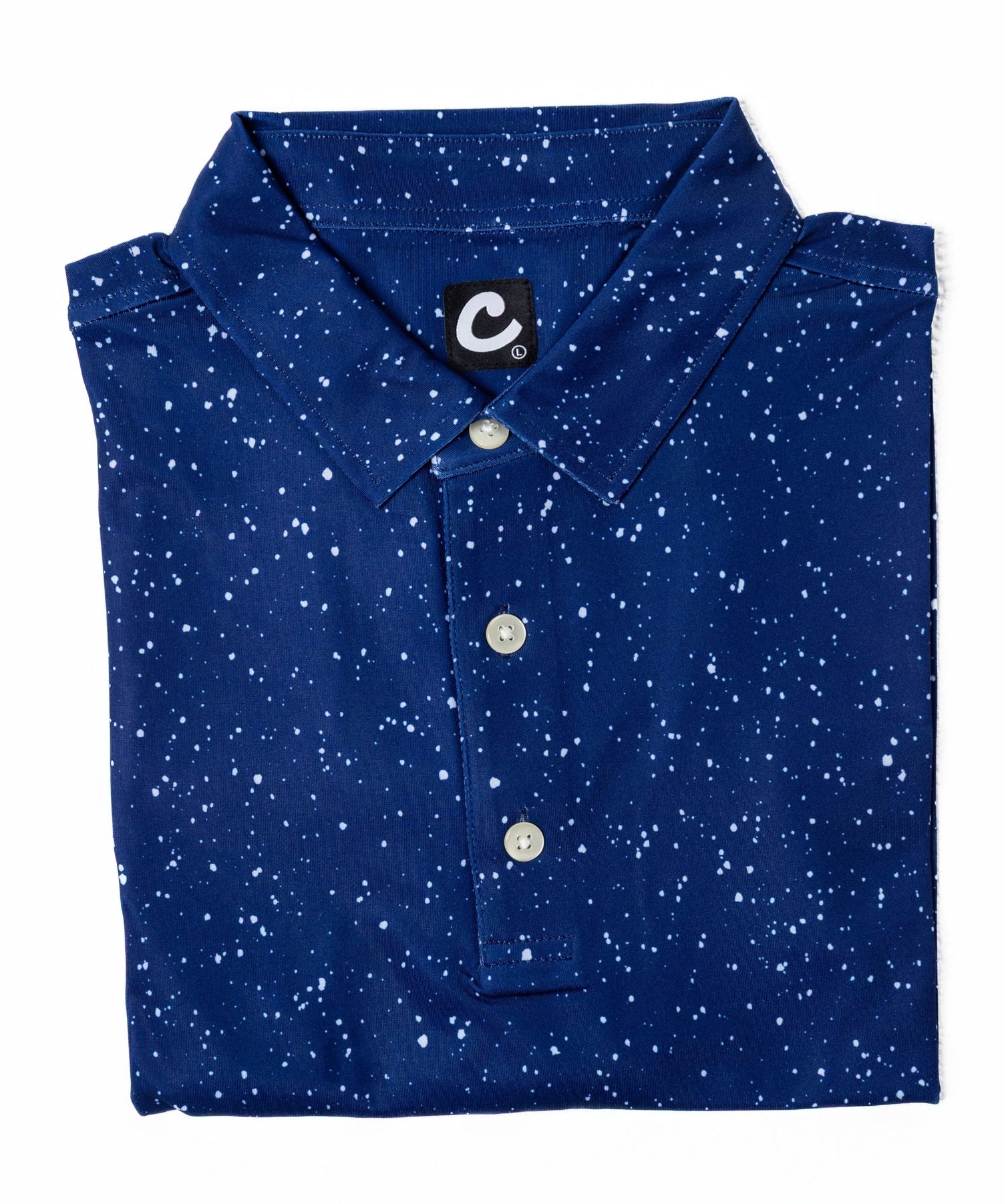 Folded blue polo shirt with white speckles on a white background
