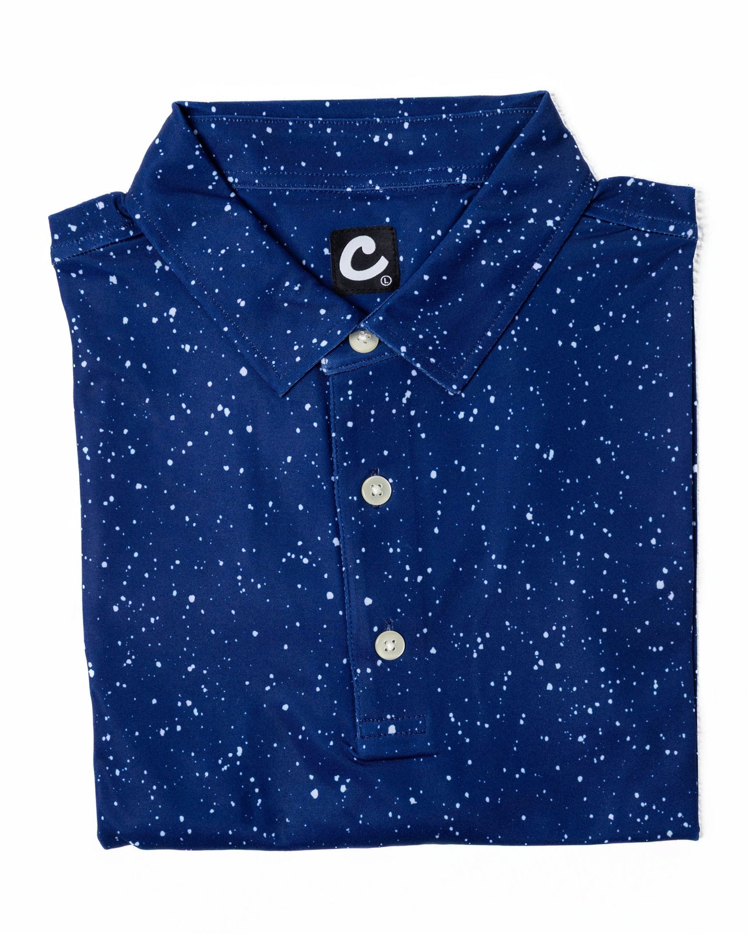 Folded blue polo shirt with white speckles on a white background