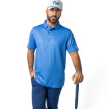 Man in blue golf attire holding a golf club on a white background